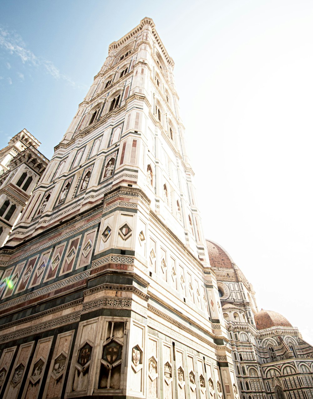 a very tall building with a clock on it's side