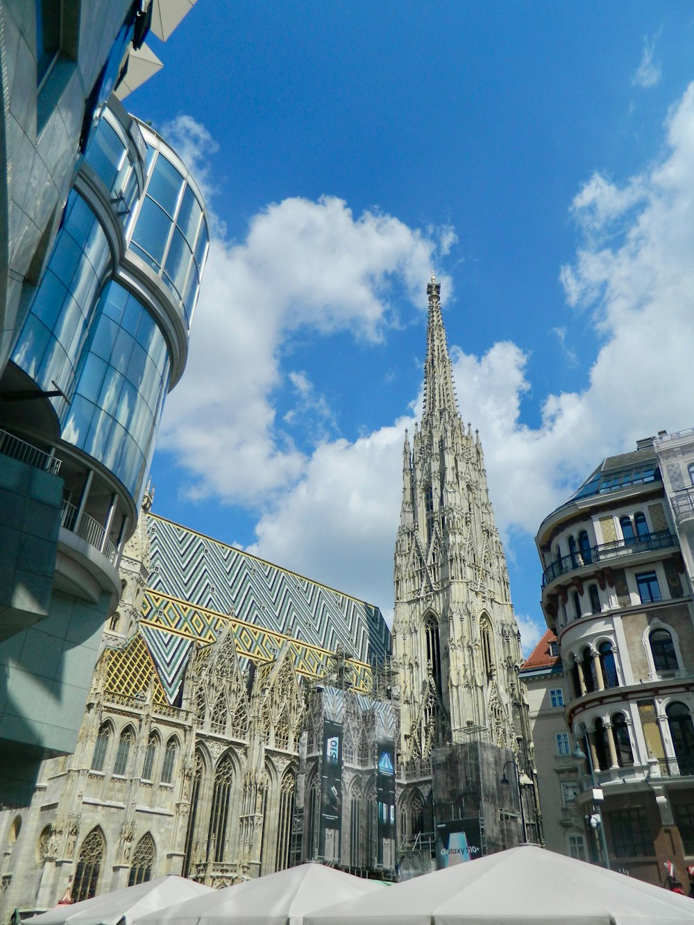 a large cathedral towering over a city filled with tall buildings