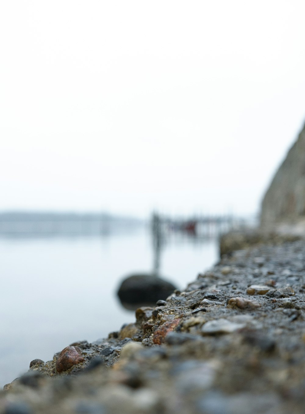 a close up of a rock wall near a body of water