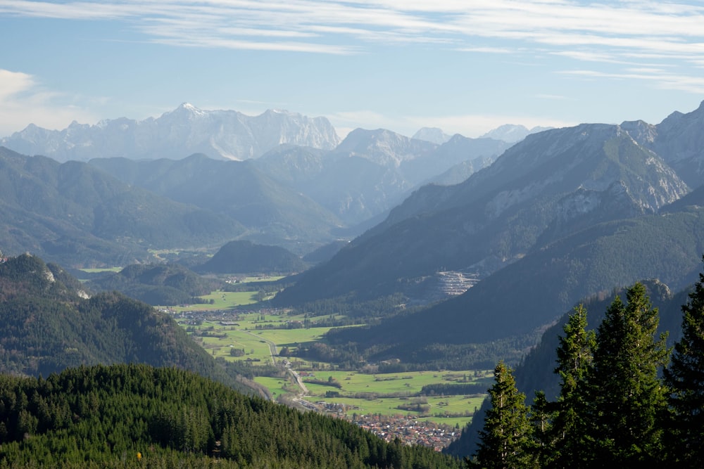 a view of a valley with mountains in the background