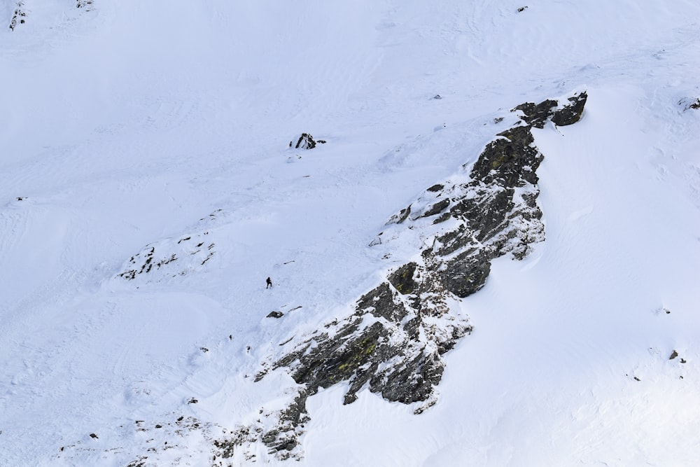 a man riding skis down the side of a snow covered slope