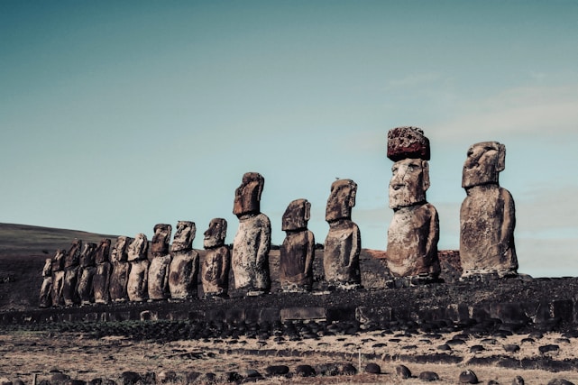 a large group of moai statues in a field