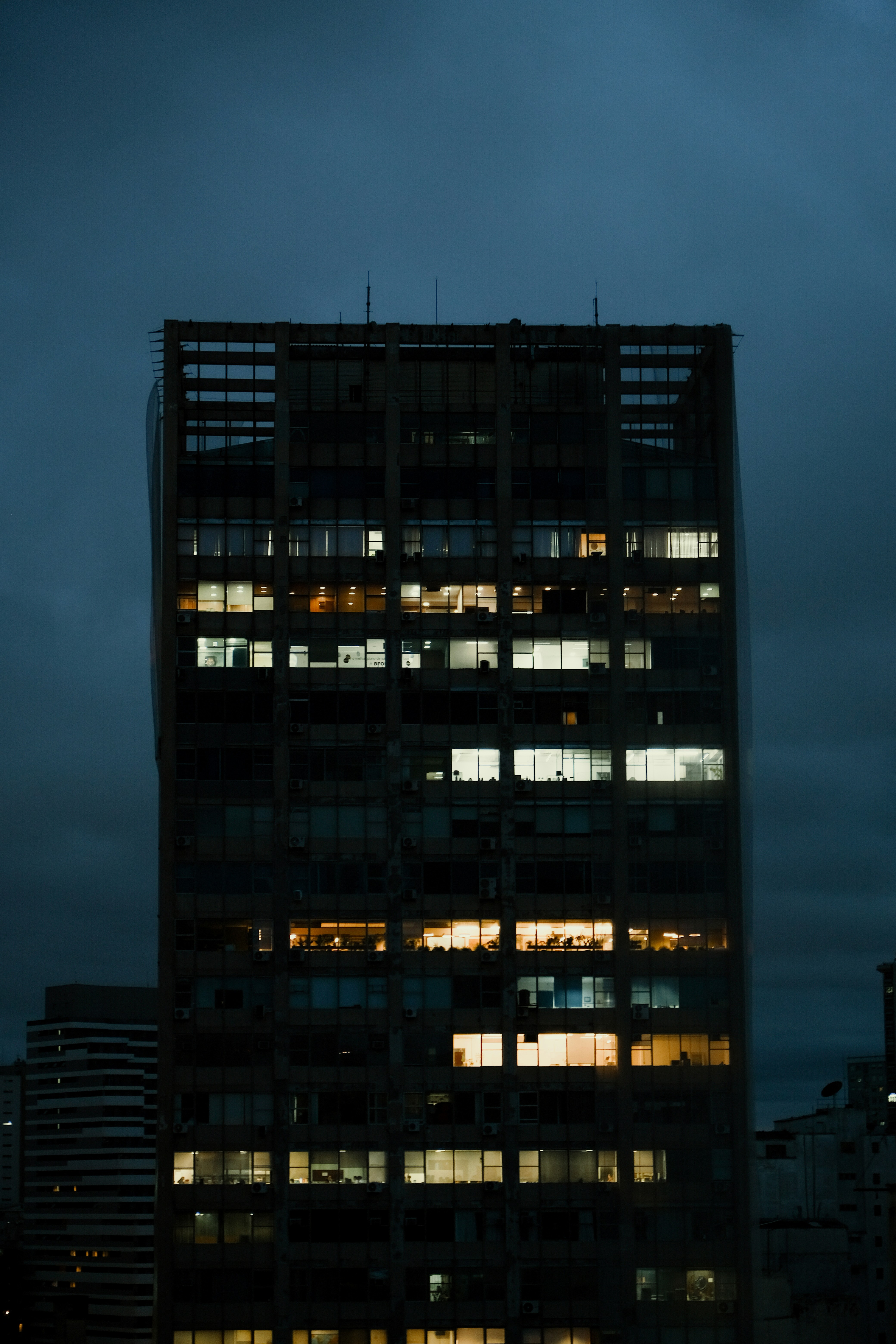 a very tall building with lots of windows at night