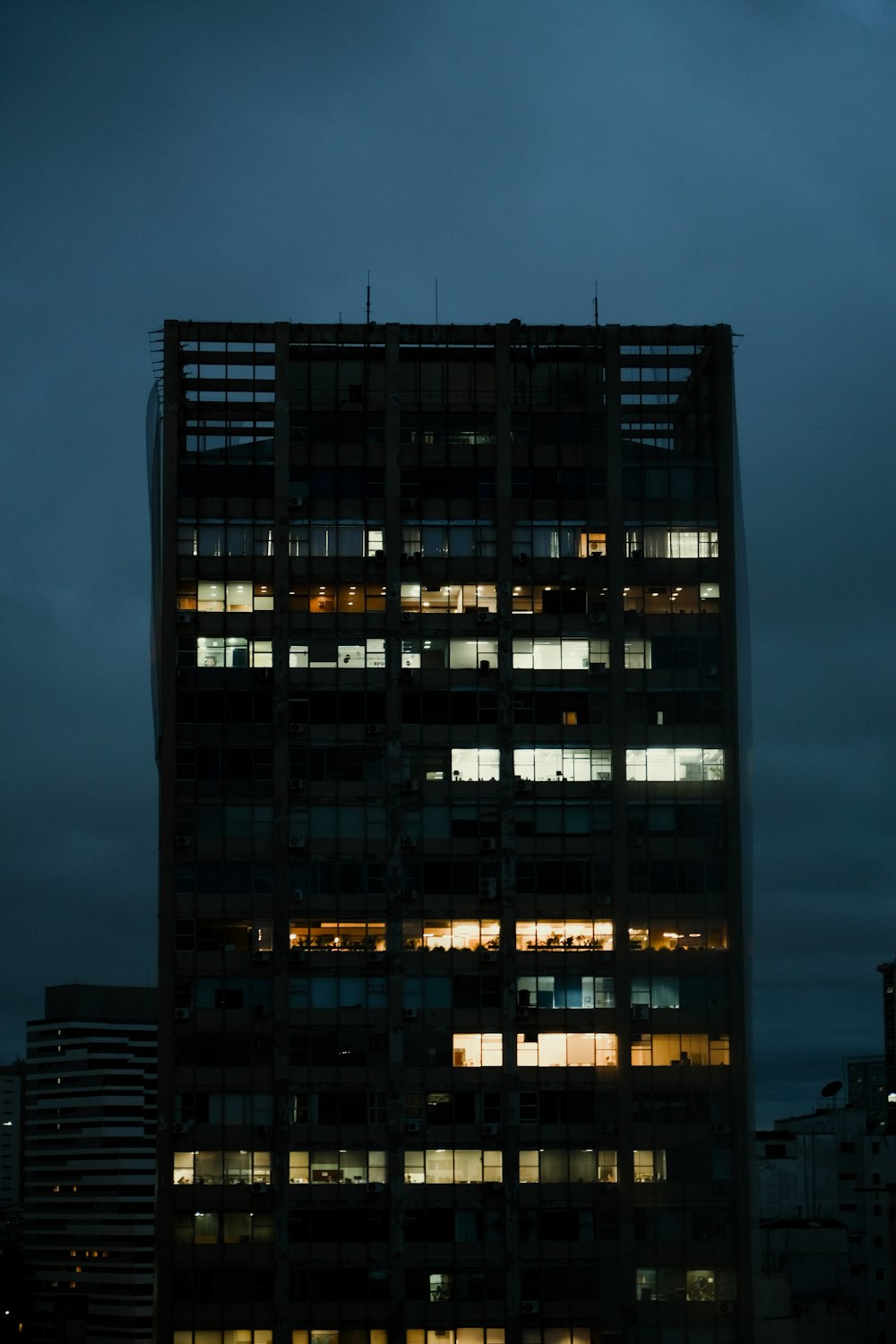 a very tall building with lots of windows at night