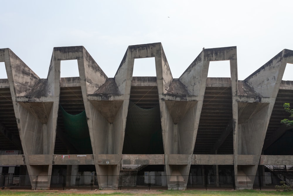 a large concrete structure sitting on top of a lush green field
