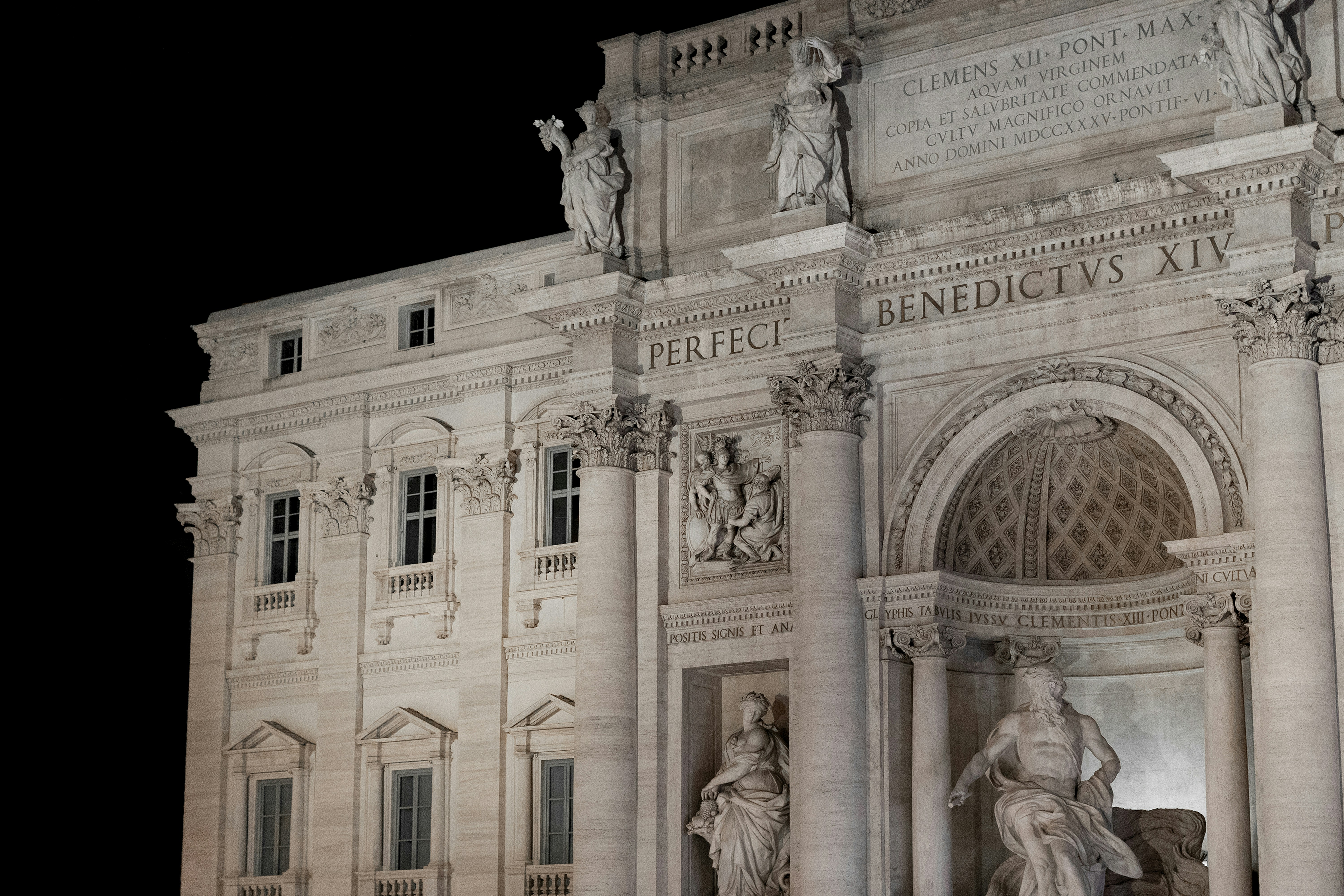 a very tall building with statues on it's sides