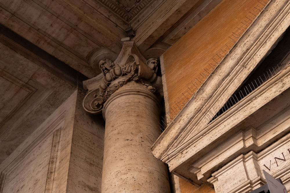 a close up of a pillar with a statue on top of it