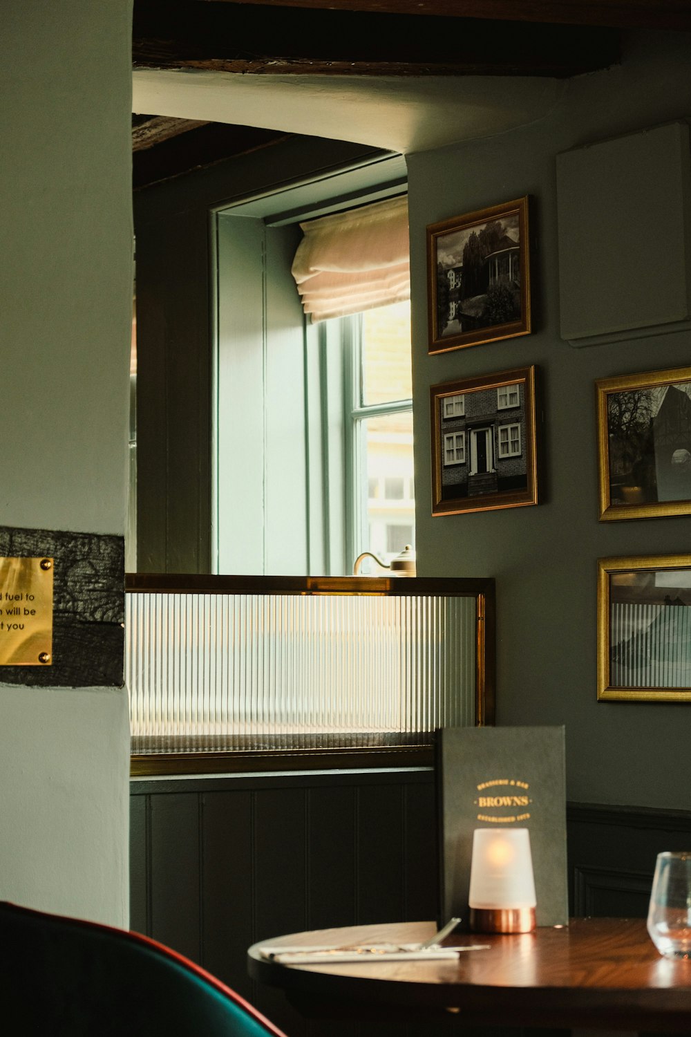 a dining room with a table and pictures on the wall