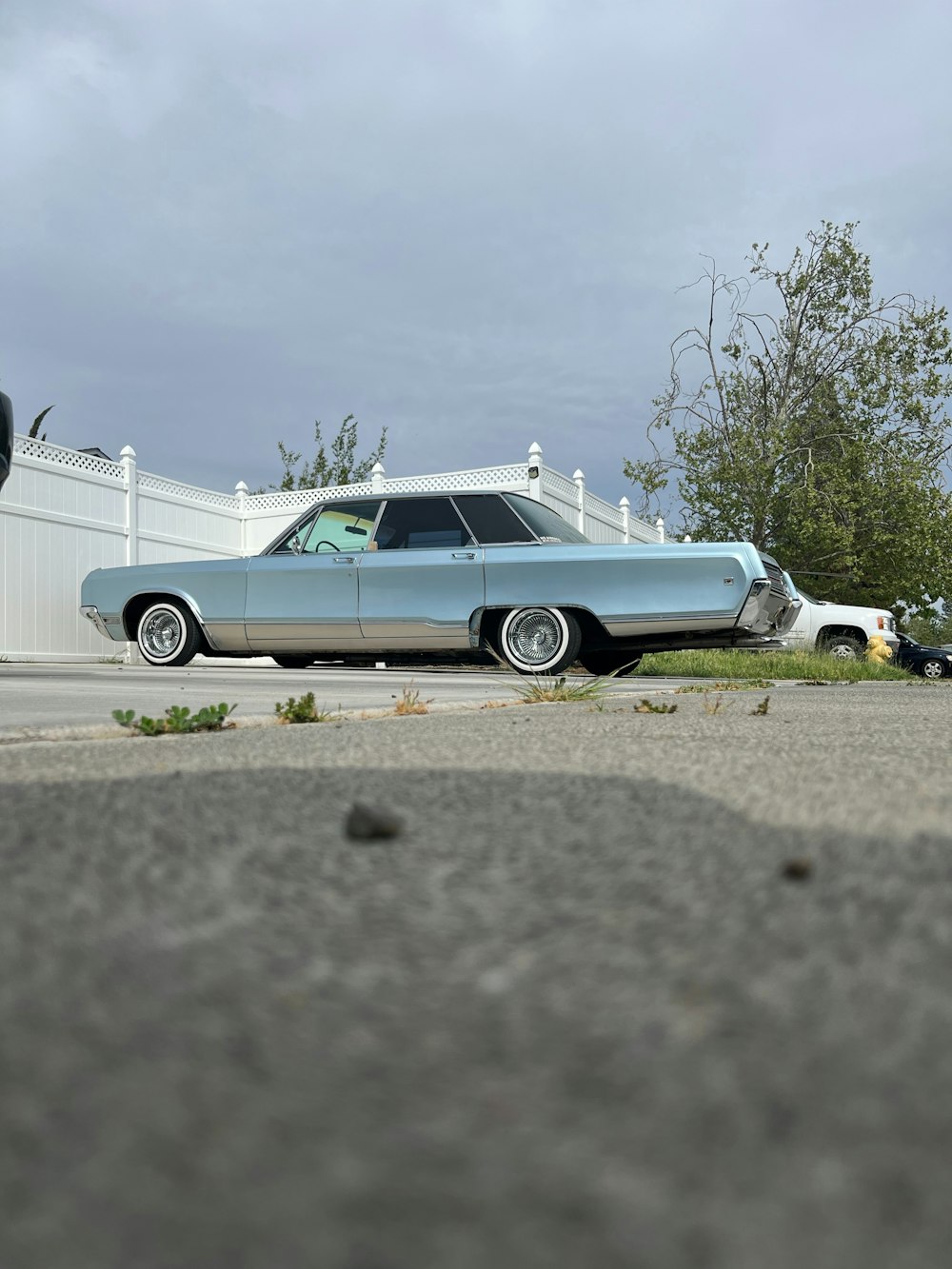 a blue car parked on the side of the road