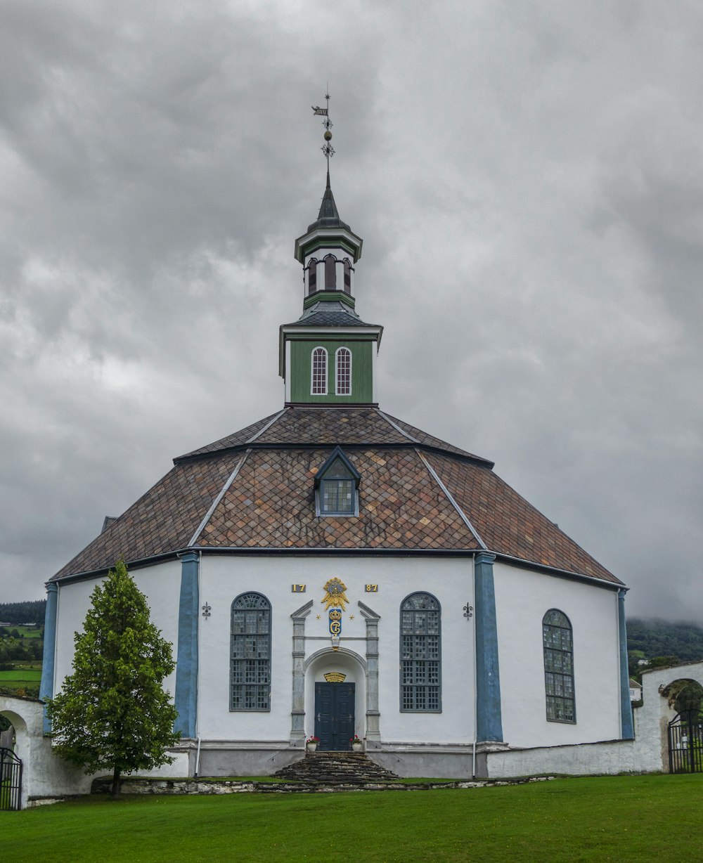 a church with a steeple on a cloudy day