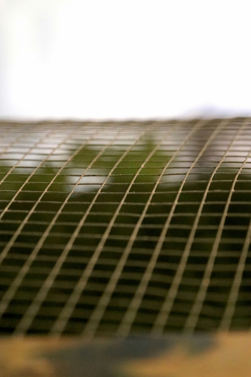 a close up of a metal grate with a blurry background