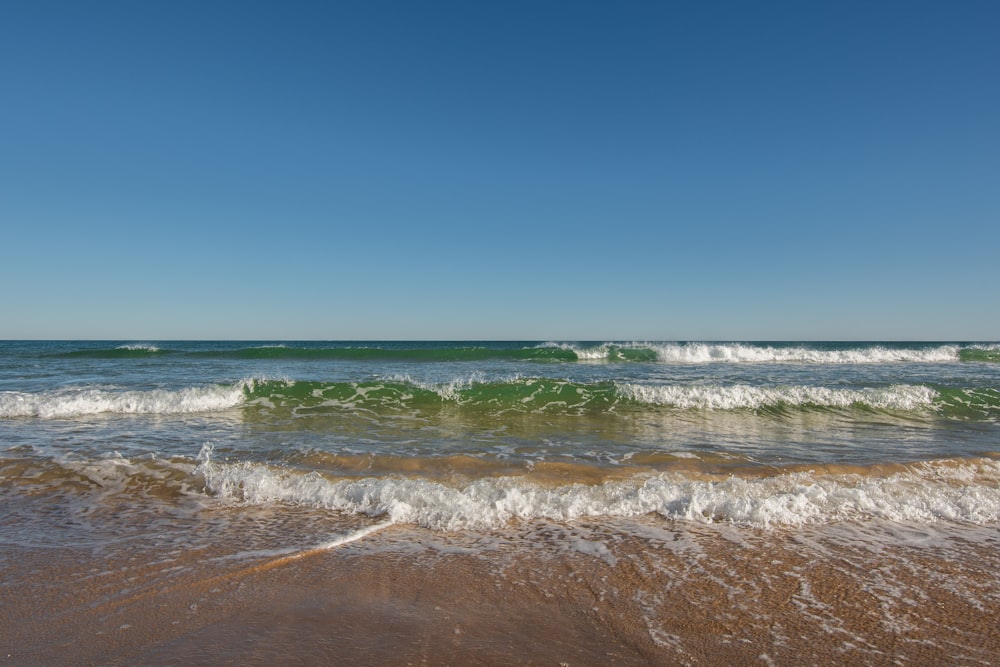 a beach with waves coming in and out of the water