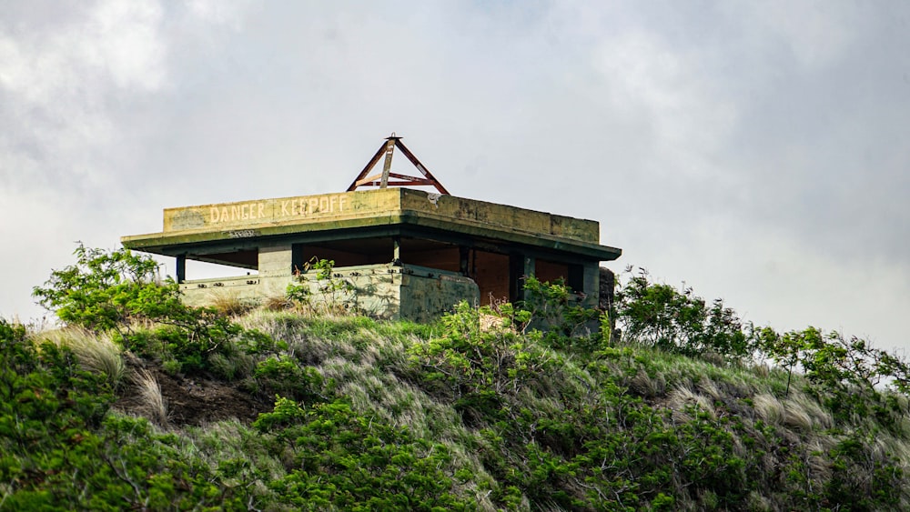 a building sitting on top of a lush green hillside