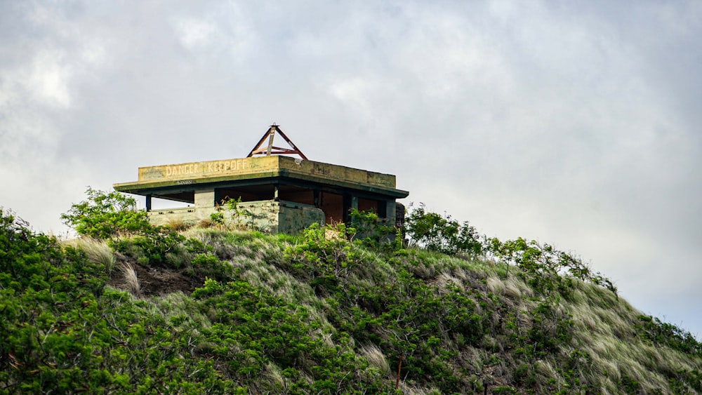 a building sitting on top of a lush green hillside