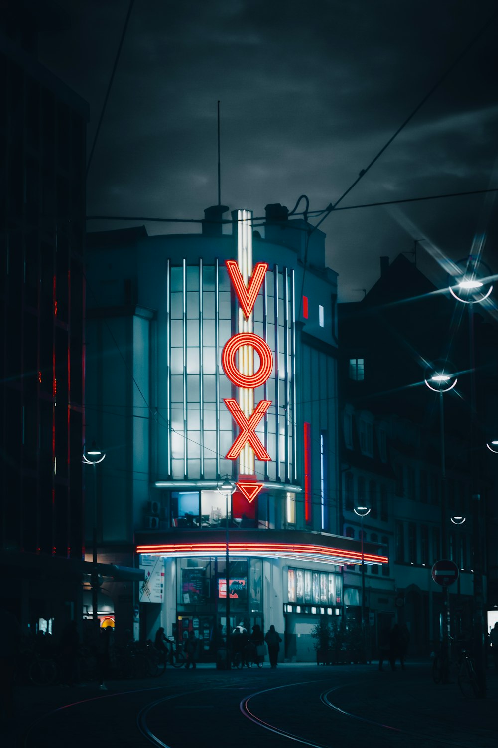 a very tall building with a neon sign on it's side