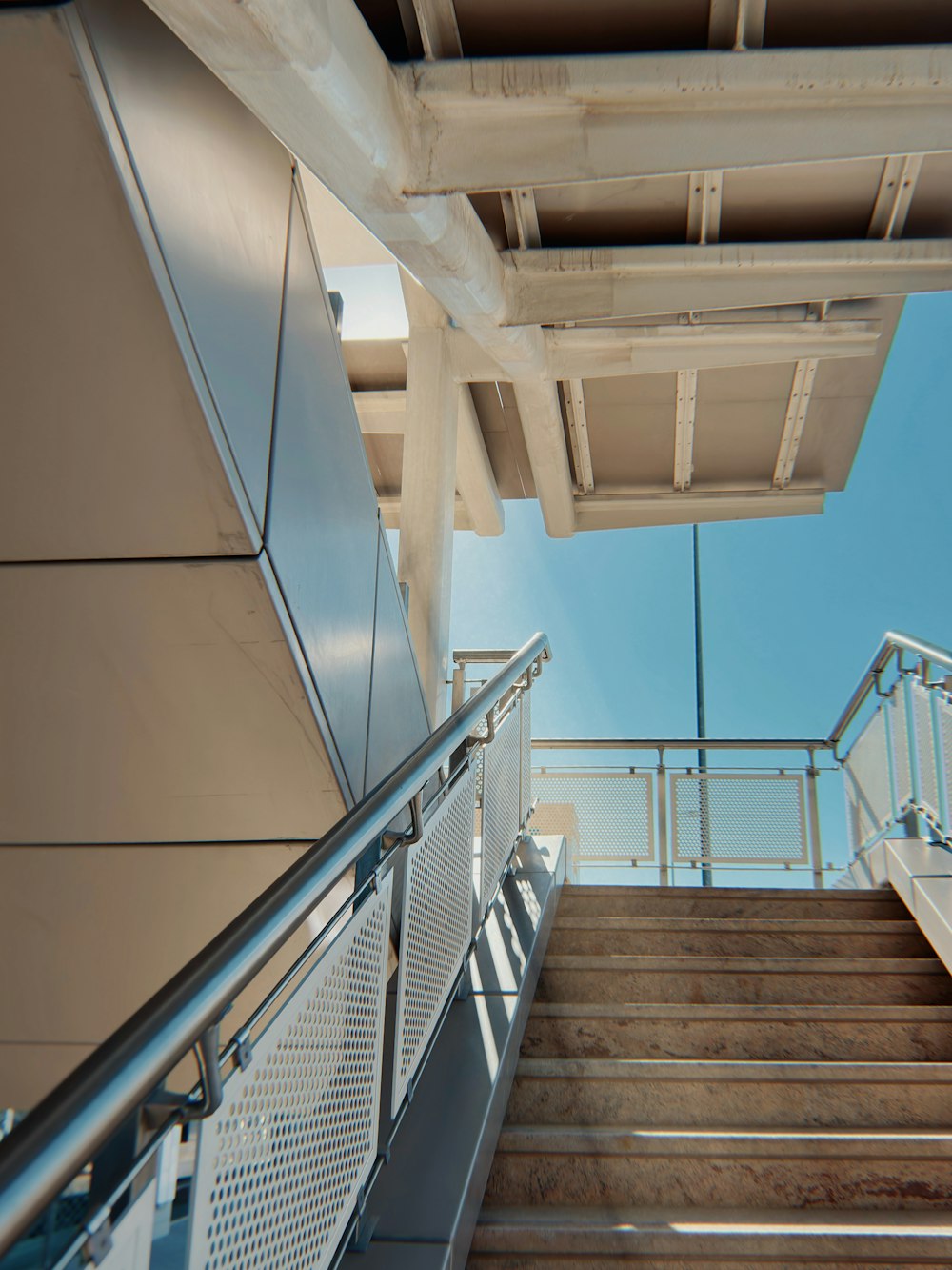 a metal hand rail next to a set of stairs