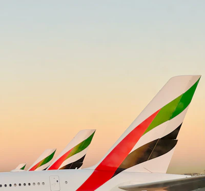 a row of airplanes sitting on top of an airport tarmac