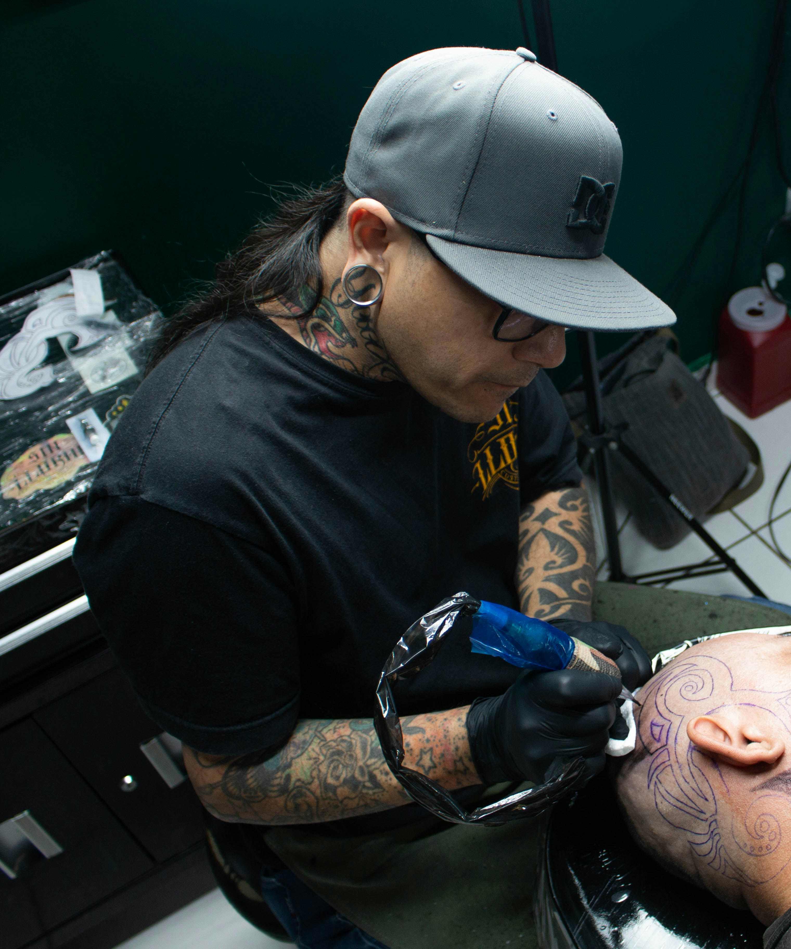 a man getting a tattoo done by a tattoo artist