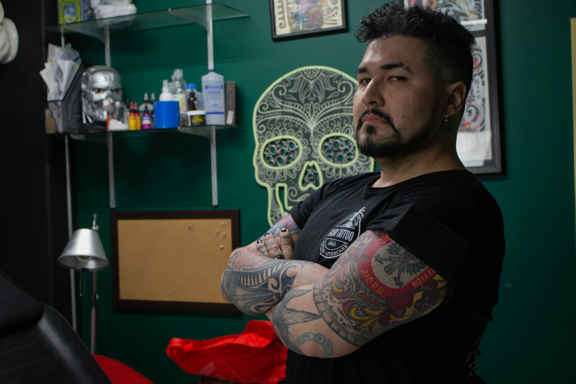 a man with tattoos standing in a room