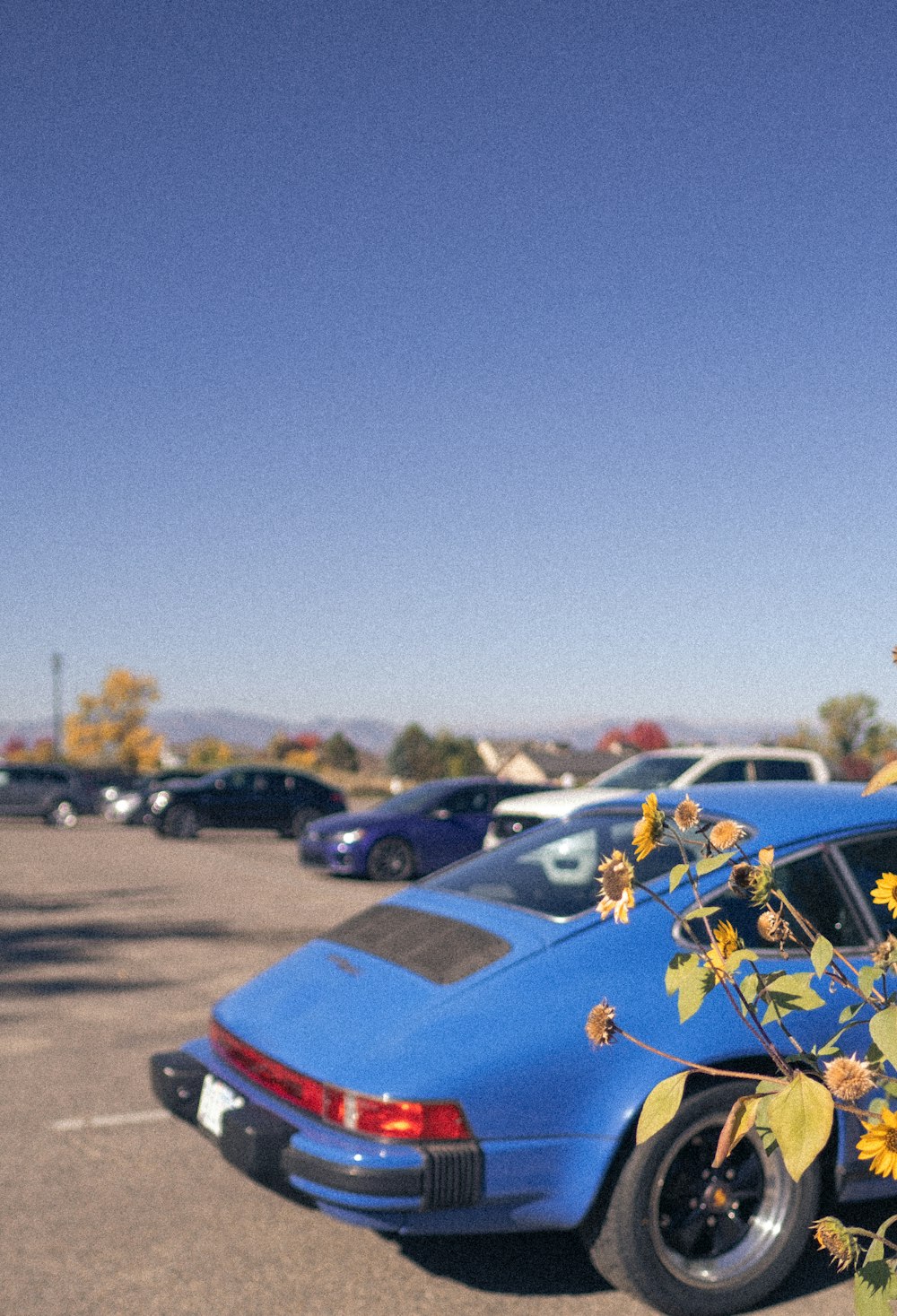 a blue car parked in a parking lot