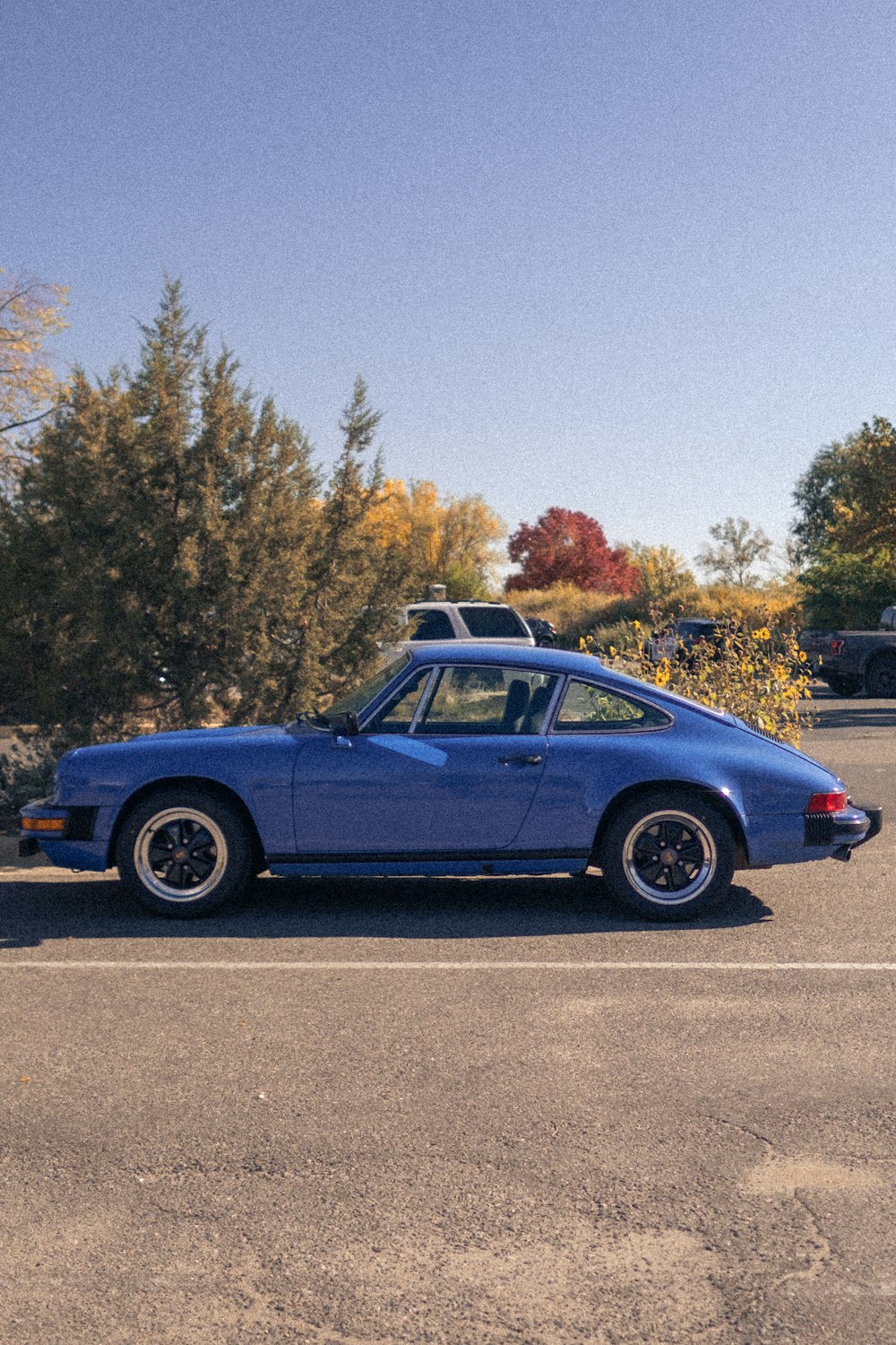 a blue car parked in a parking lot