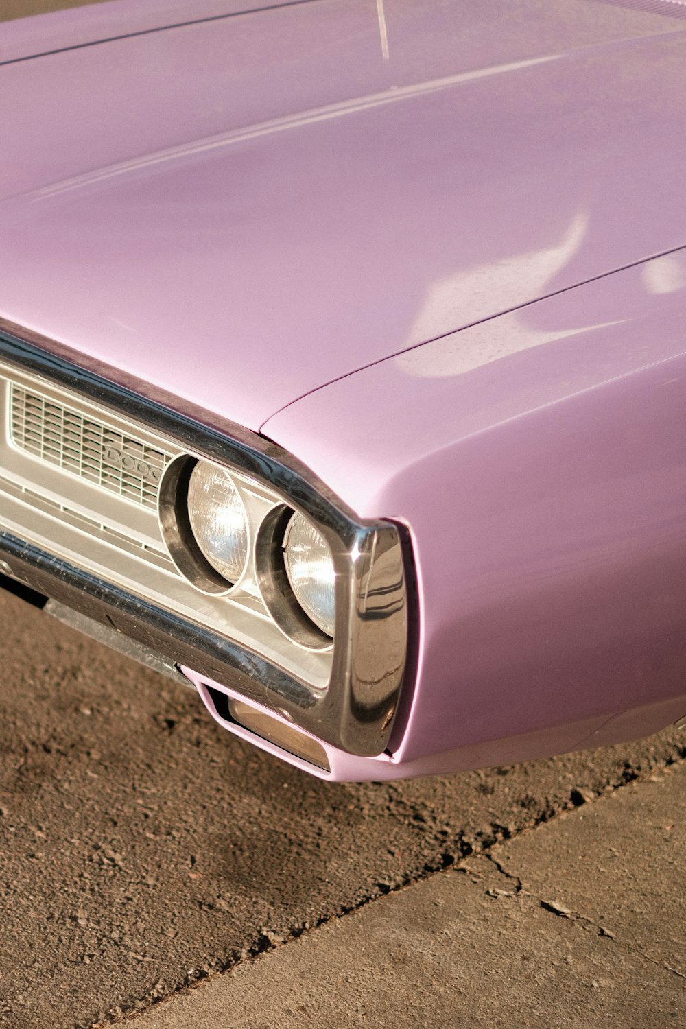 a close up of the front end of a purple car