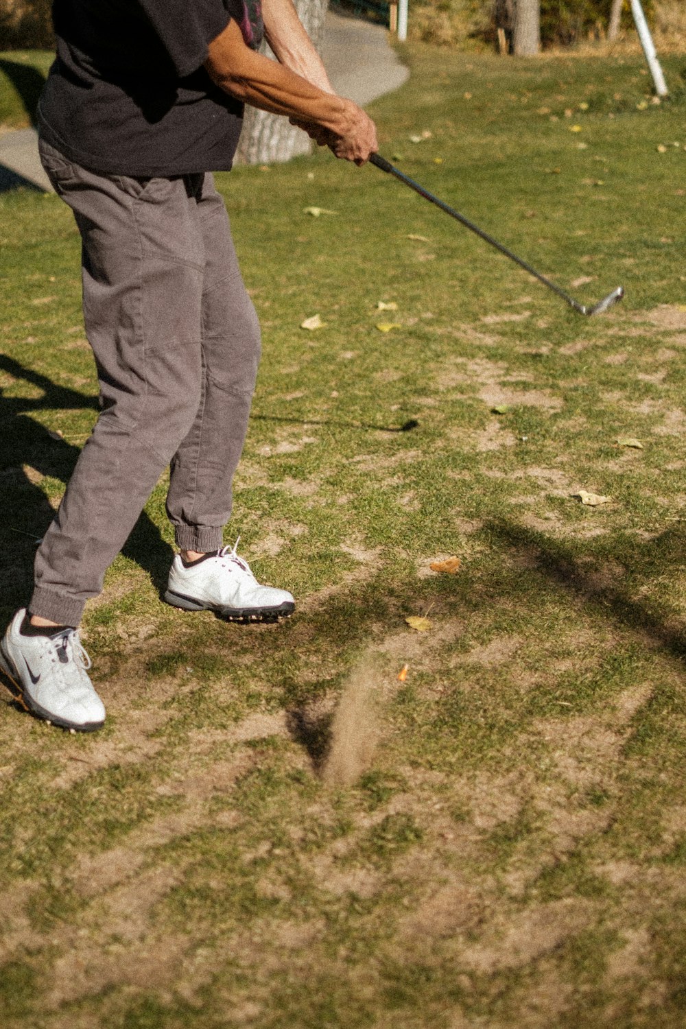 a man hitting a golf ball with a golf club