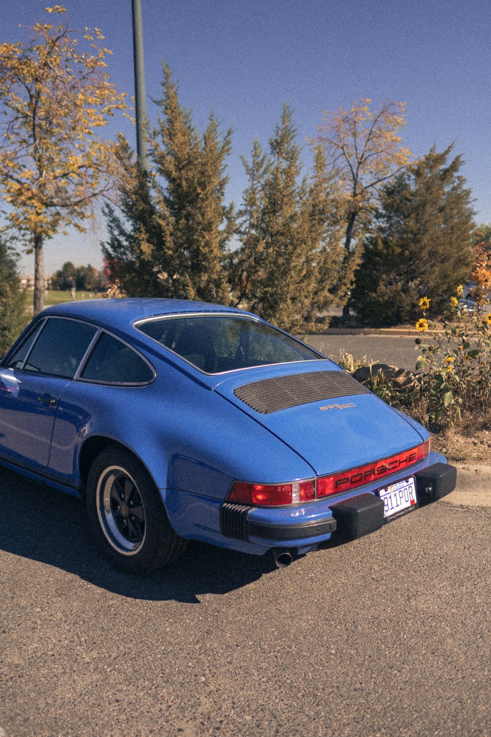 a blue sports car parked in a parking lot