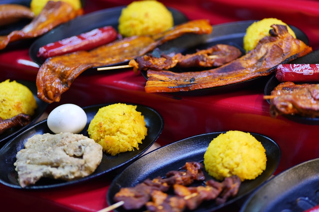 a table topped with black plates filled with food