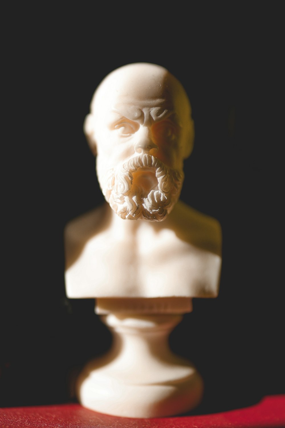 a white busturine of a man with a beard