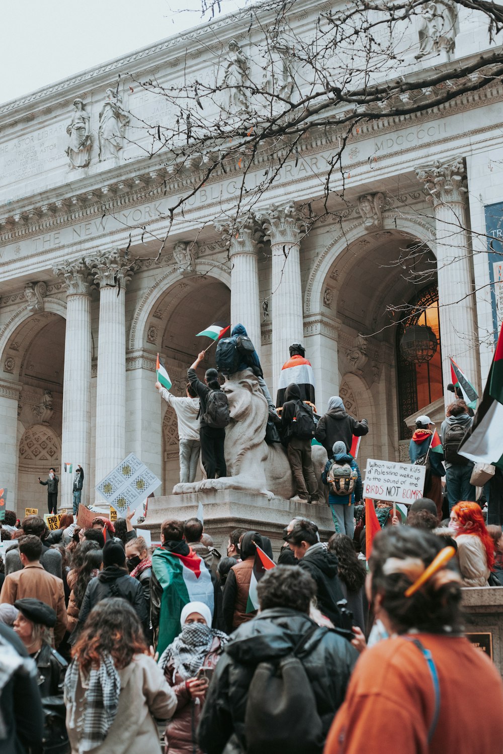 a crowd of people standing in front of a building