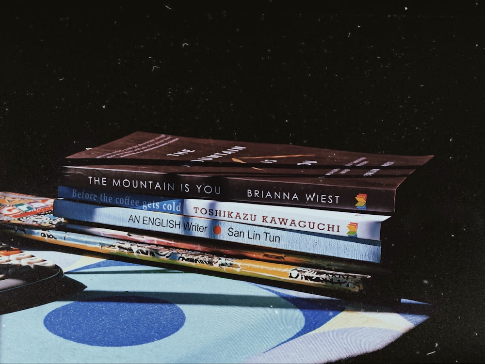 a stack of books sitting on top of a table