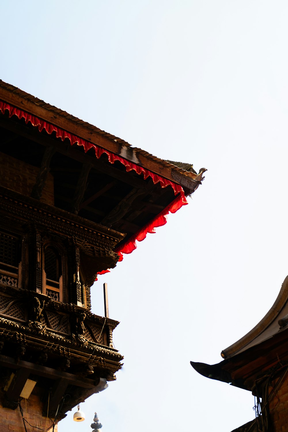 a bird is perched on the roof of a building