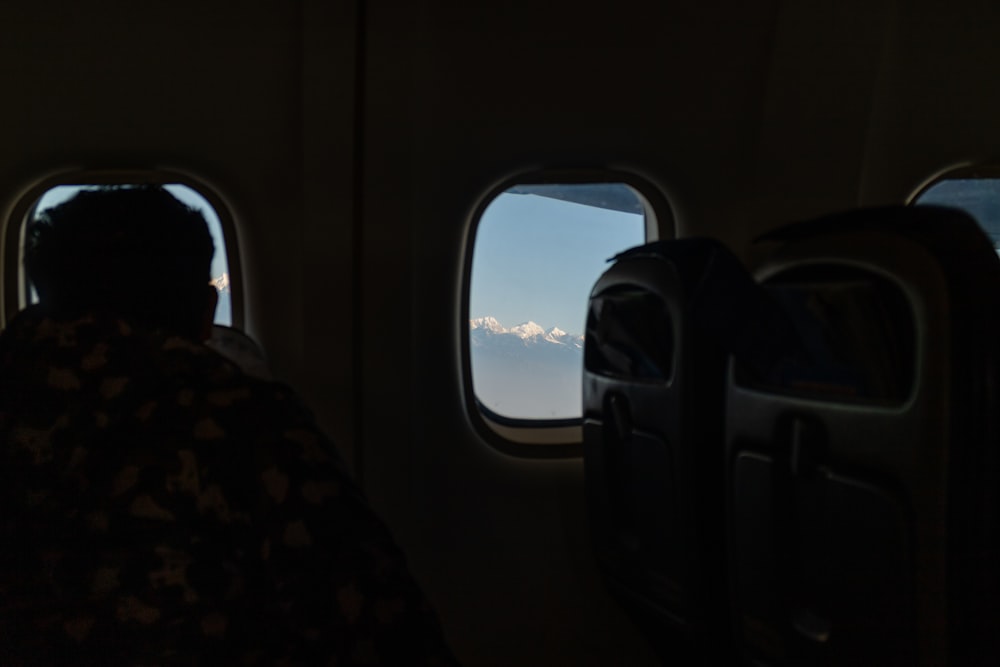 a person looking out of an airplane window