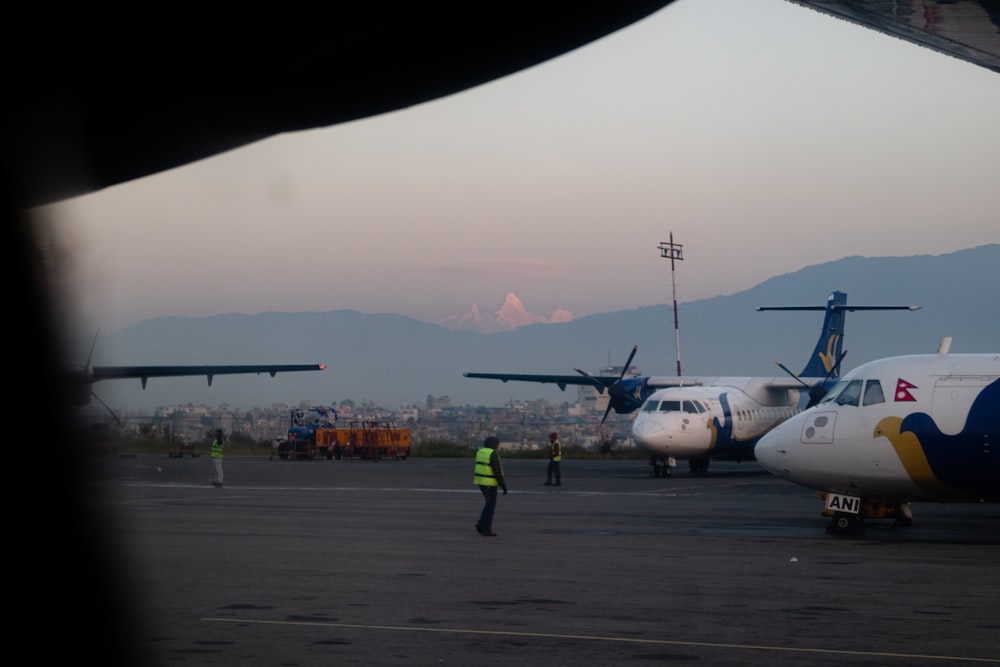 a couple of airplanes that are on a runway