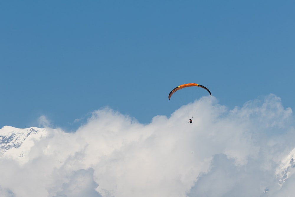 a paraglider is flying high in the sky