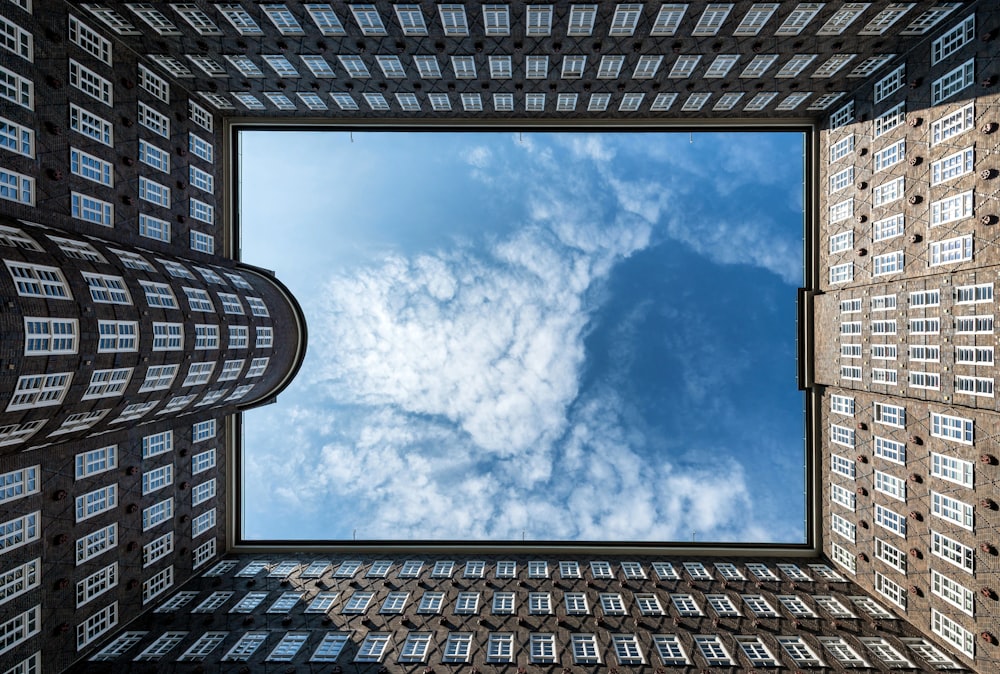a view of a building from the ground looking up at the sky