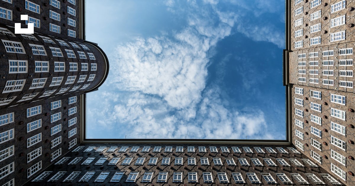 A view of a building from the ground looking up at the sky photo – Free ...