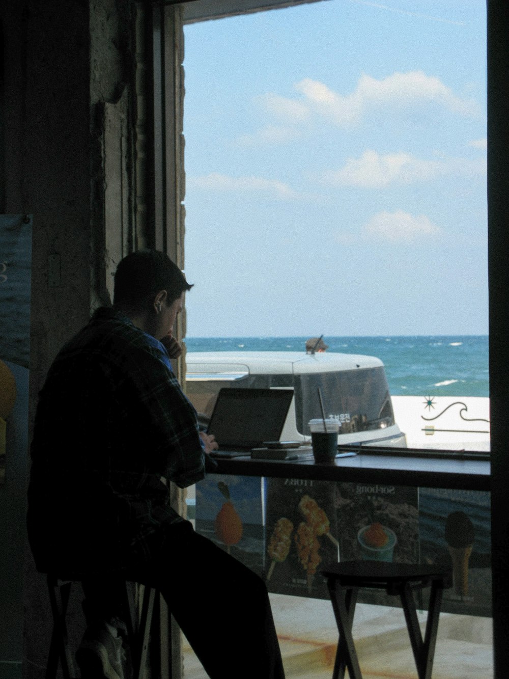 a man sitting at a table using a laptop computer