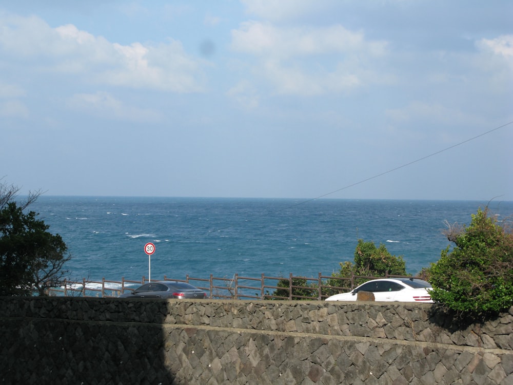 a car parked on the side of a road next to the ocean