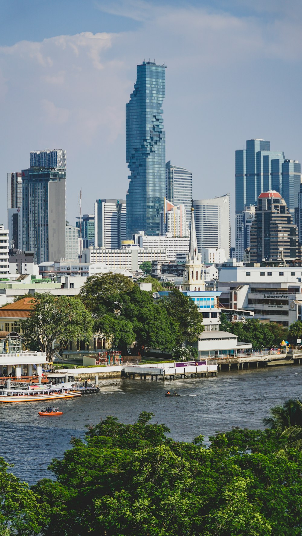 a city skyline with a body of water in the foreground