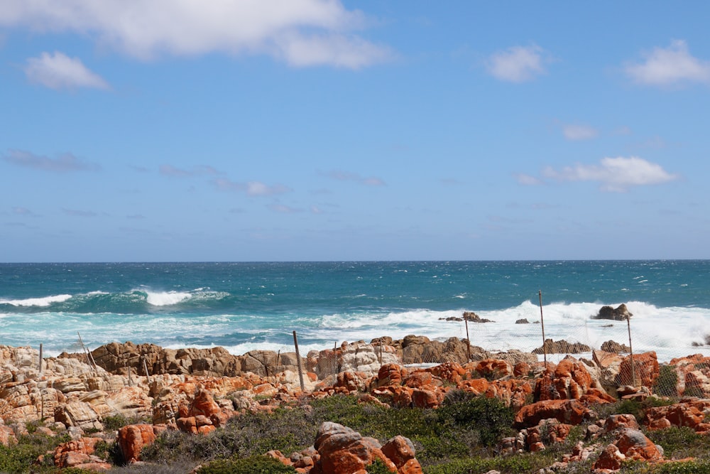 a view of the ocean from a rocky shore