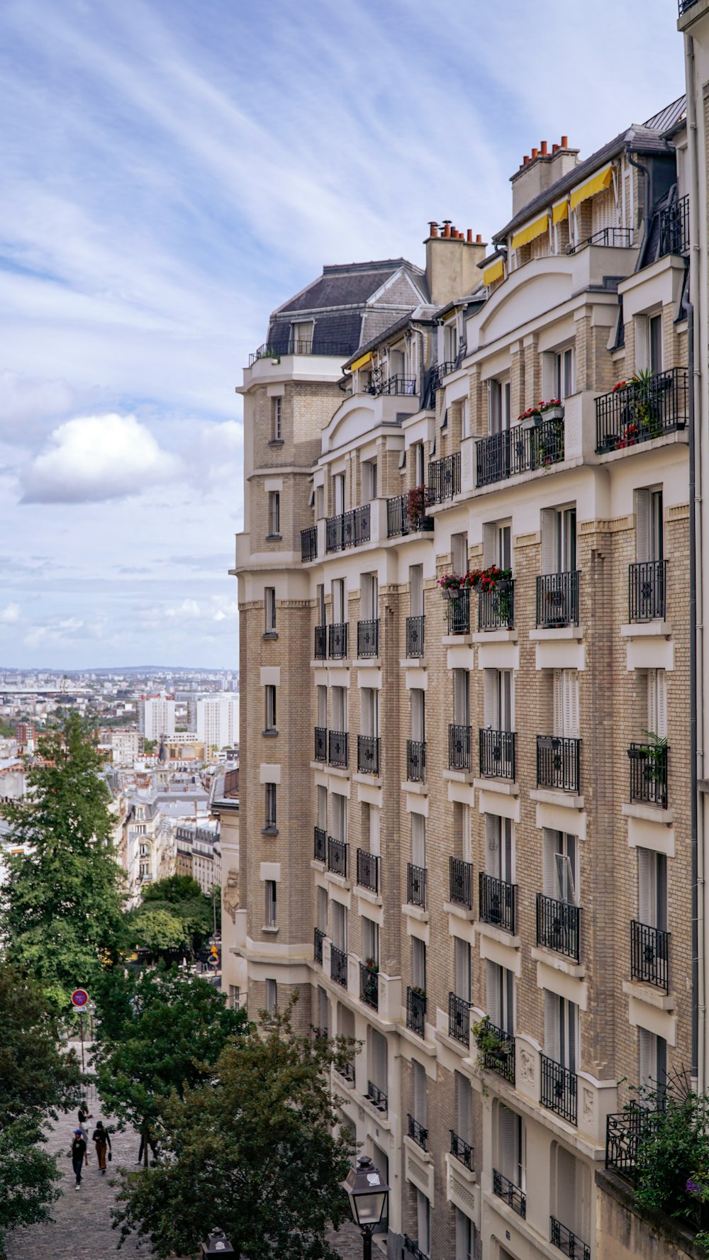 a tall building with balconies on the top of it