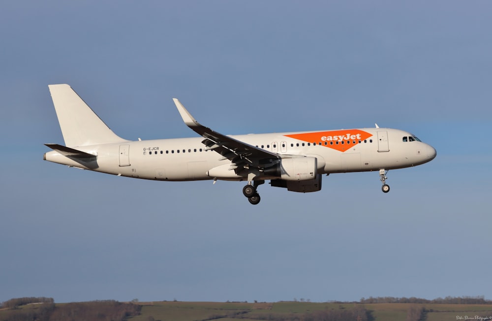 a large jetliner flying through a blue sky