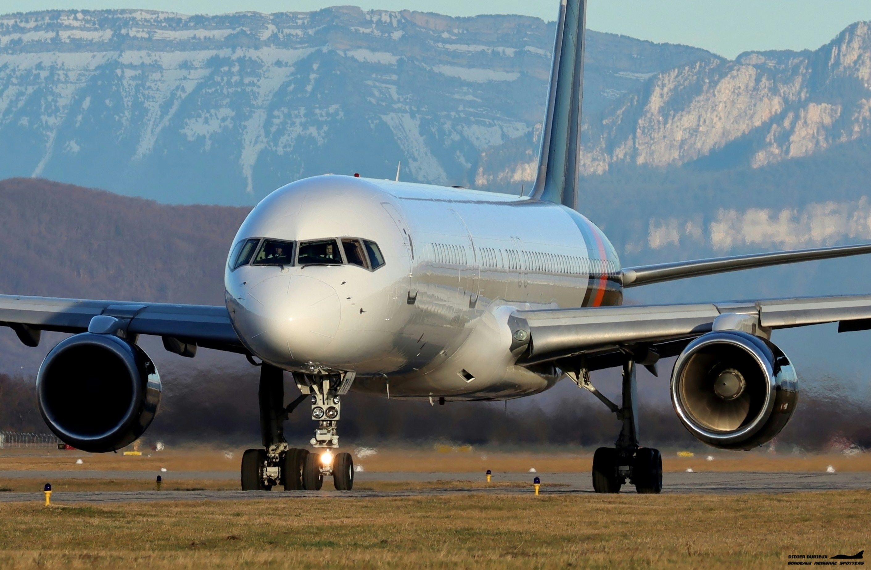 a large jetliner sitting on top of an airport runway, 