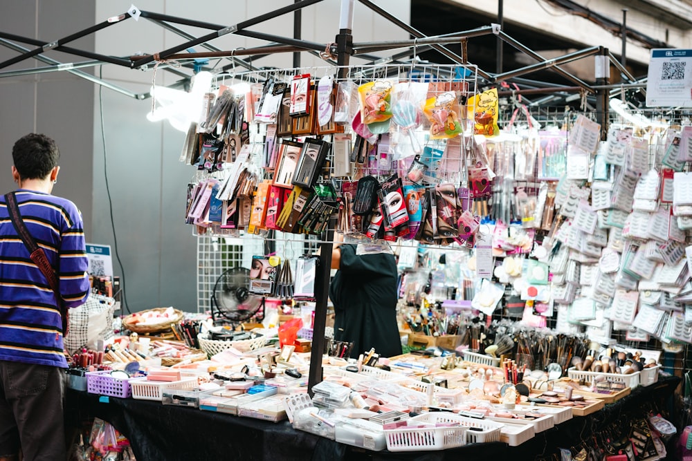 a man standing in front of a table with a lot of items on it