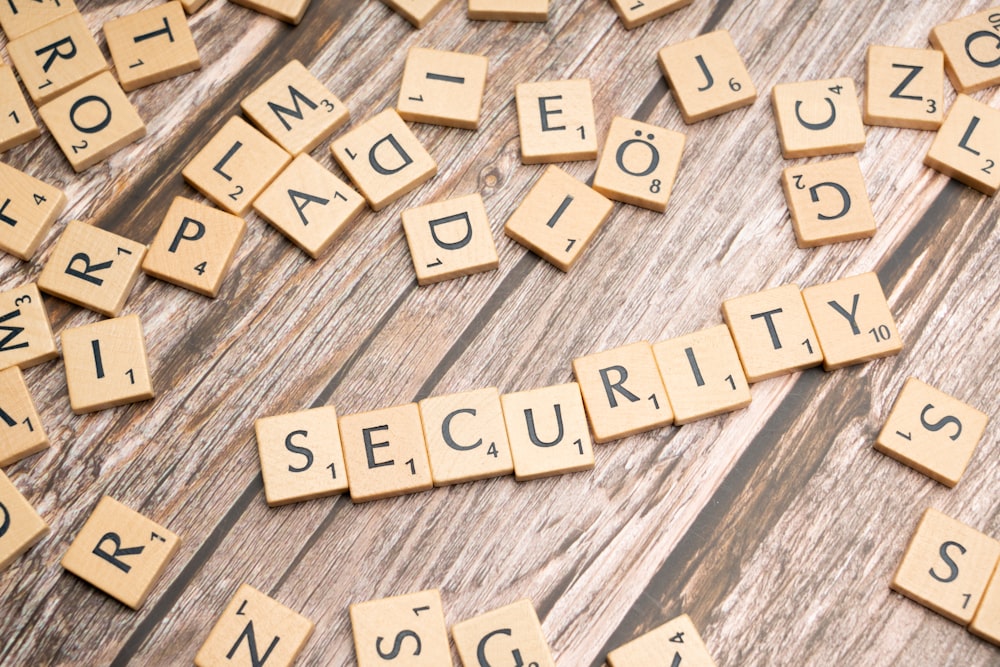 scrabble tiles spelling security on a wooden surface