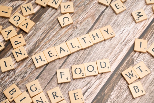 scrabble tiles spelling out the word healthy on a wooden surface