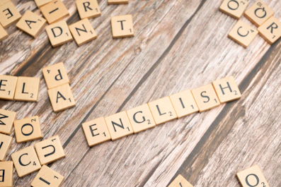 a close up of scrabble letters on a wooden surface
