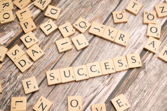 scrabble tiles spelling out the word love on a wooden surface